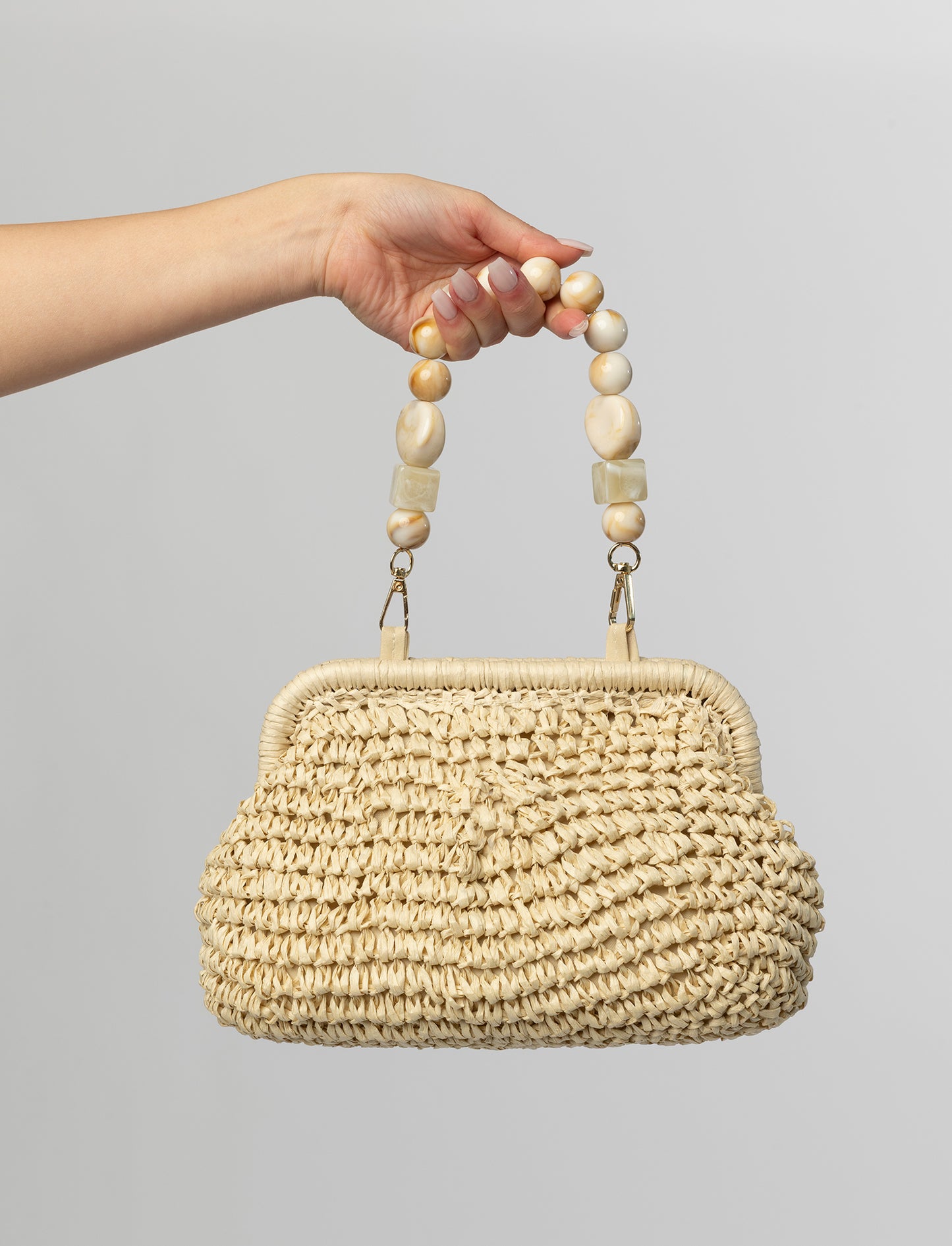 Beige woven clutch with beaded handle