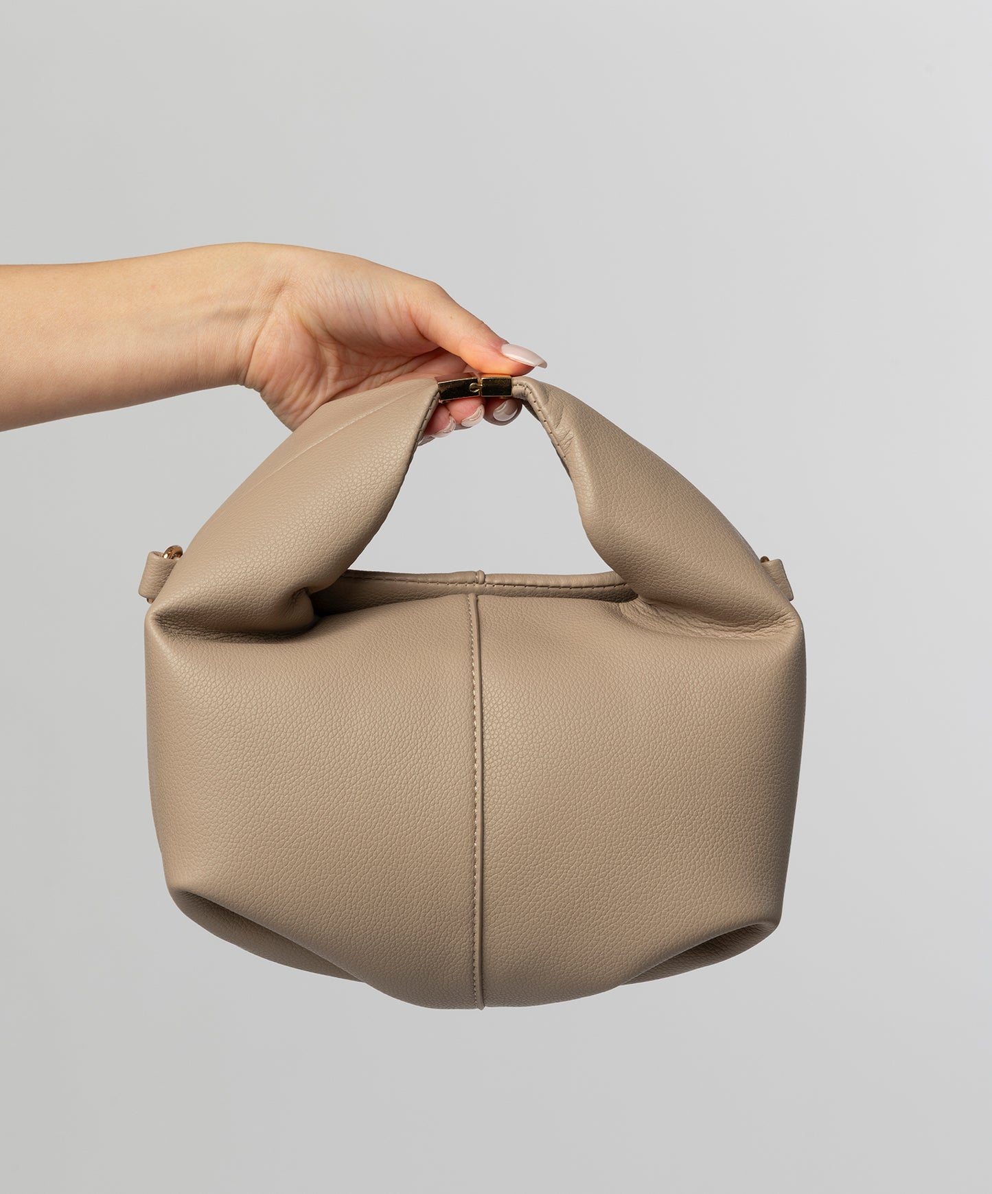 Beige leather top handle bag with buckle